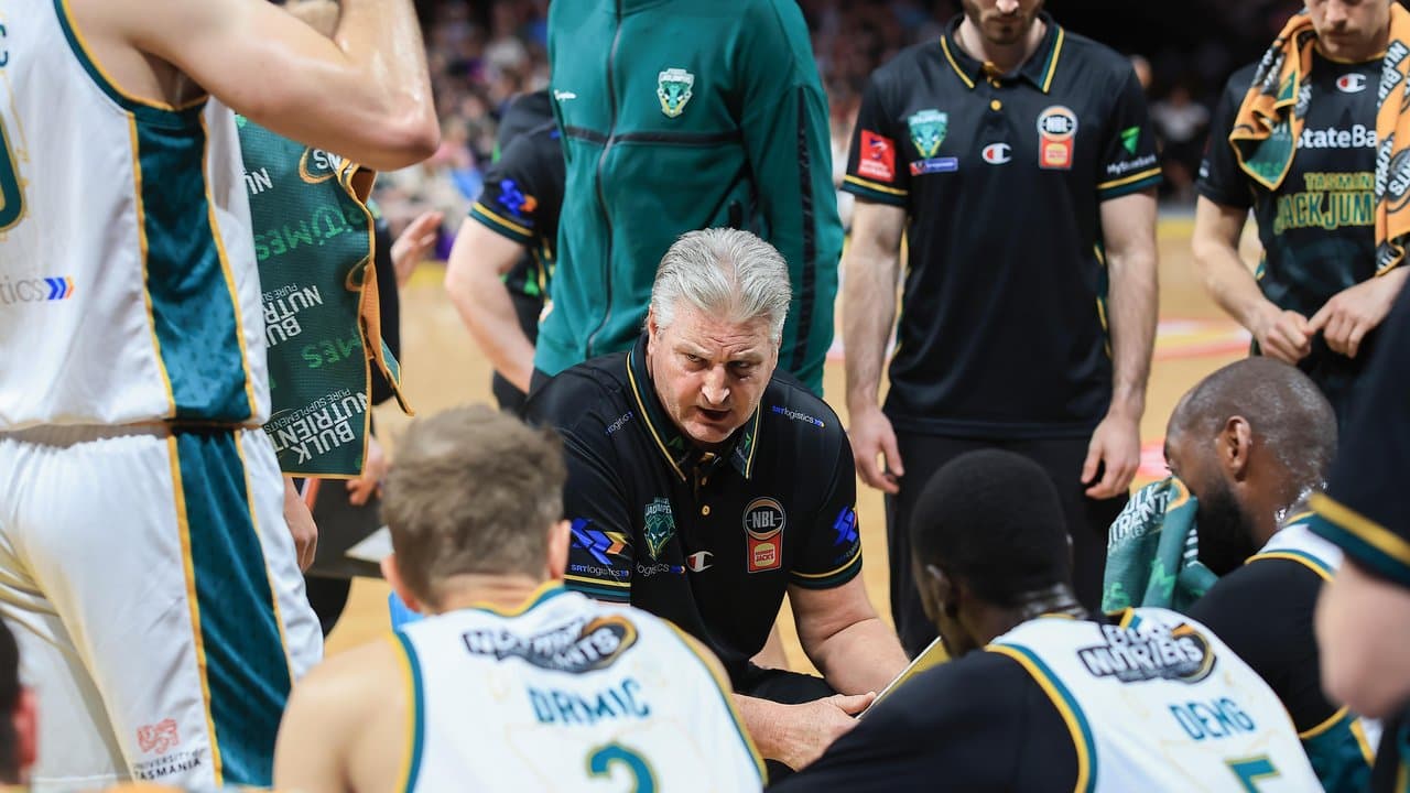 JackJumpers coach Scott Roth (centre) urges his players to lift.