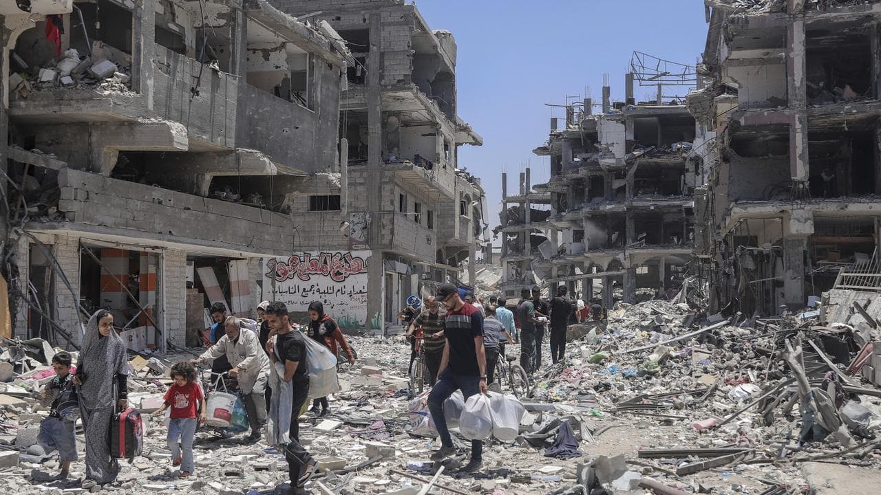 Palestinians in the destruction after Israeli attacks in Jebaliya
