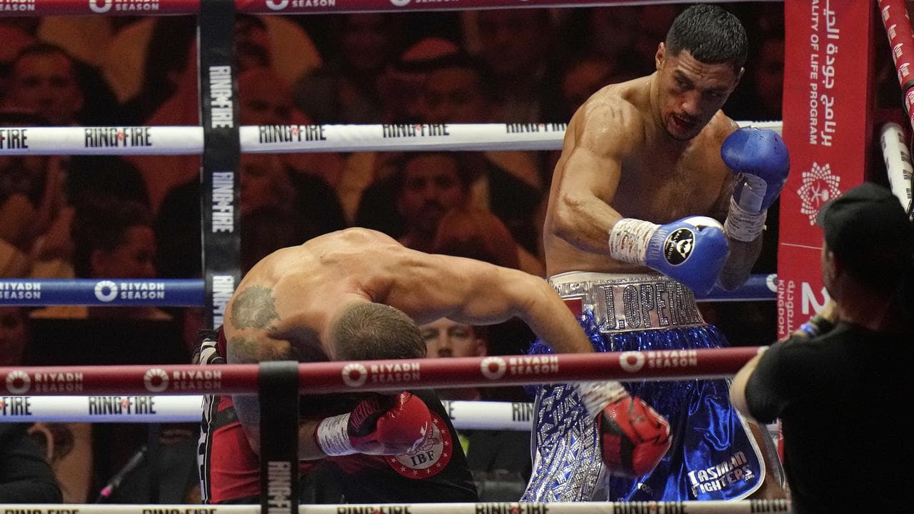 Jai Opetaia (right) trades blows with Latvia's Mairis Briedis.