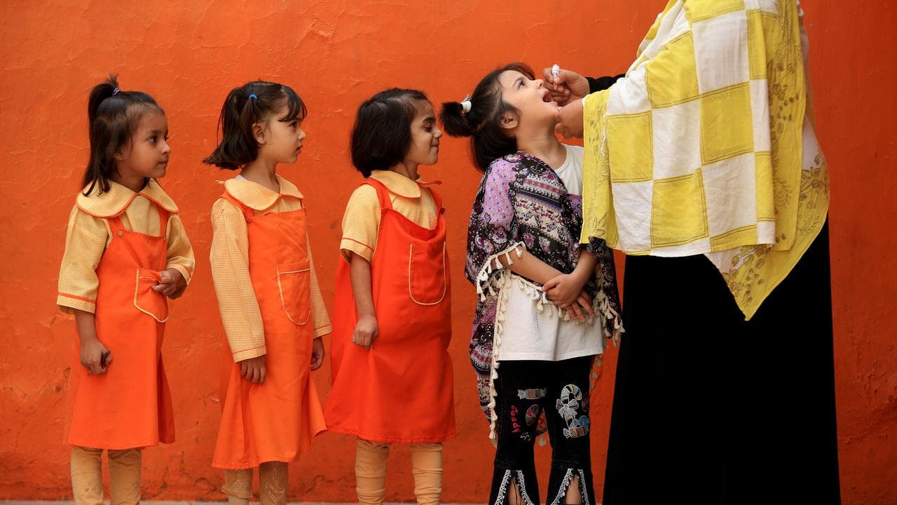 Children getting polio vaccines in Pakistan.