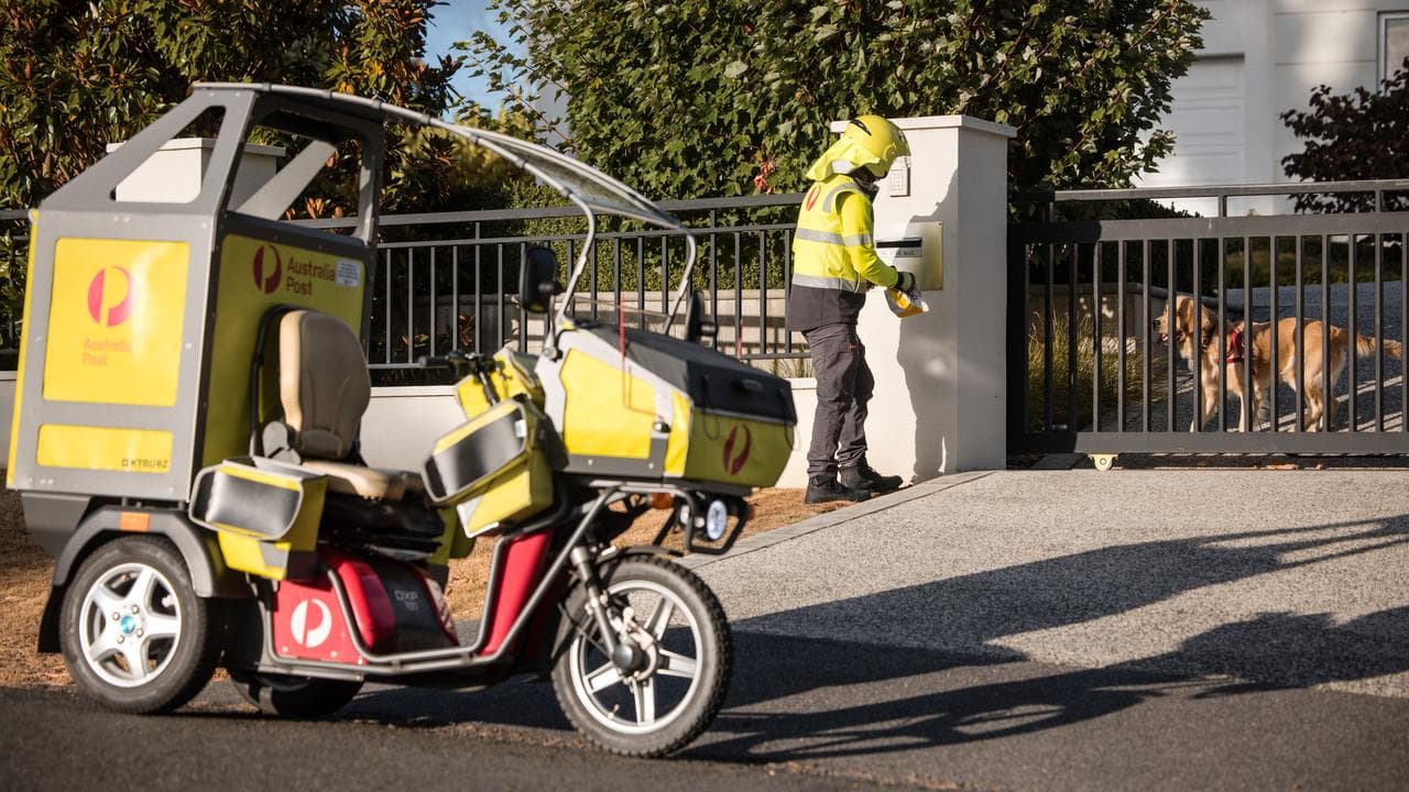 A postie delivering mail