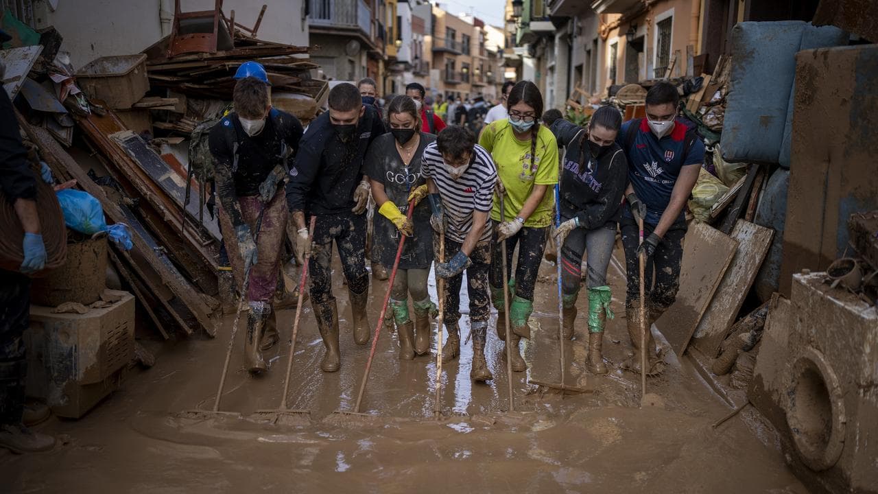 Volunteers clean up the mud