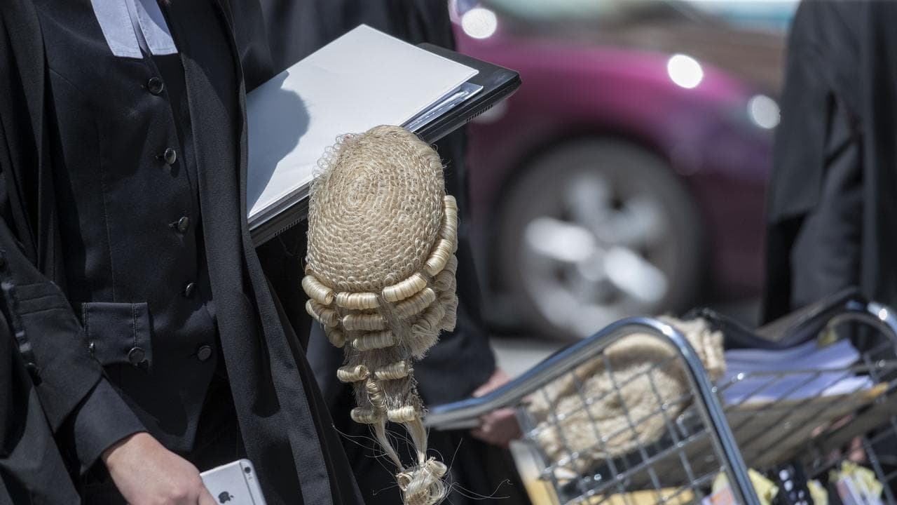 Barrister carries documents and wig (file image)