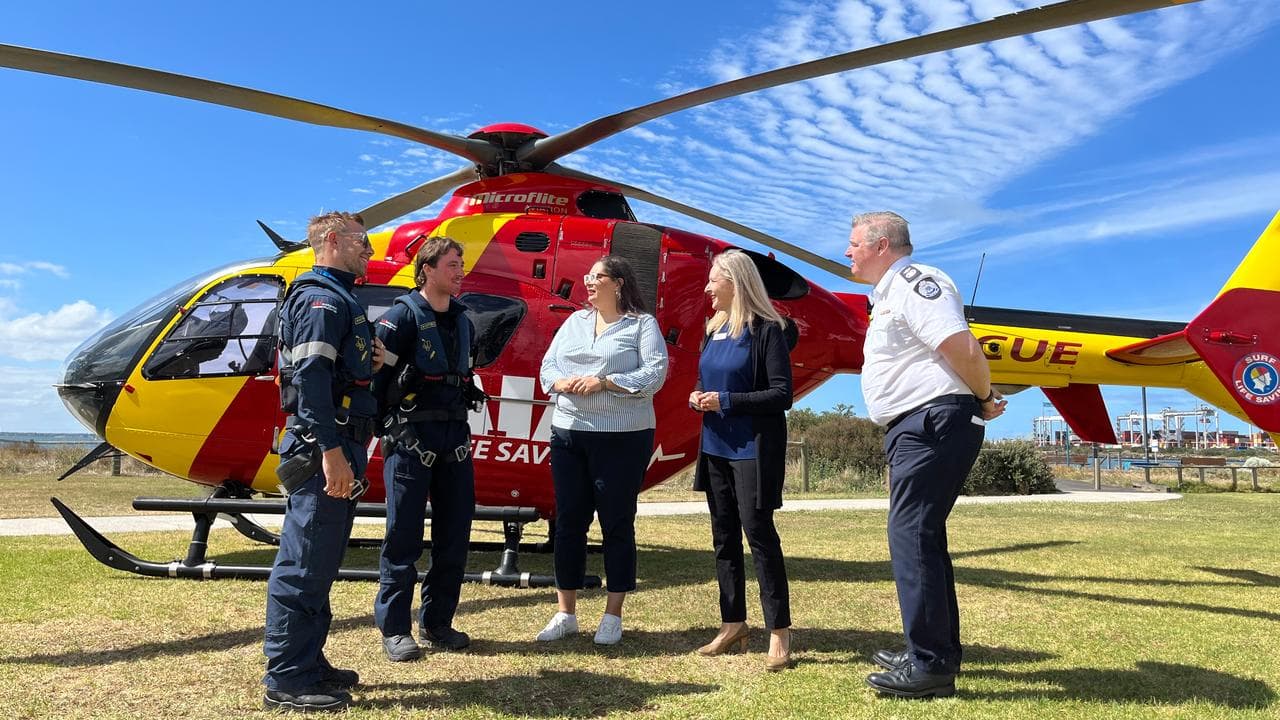 Rescue helicopter personnel chat with officials