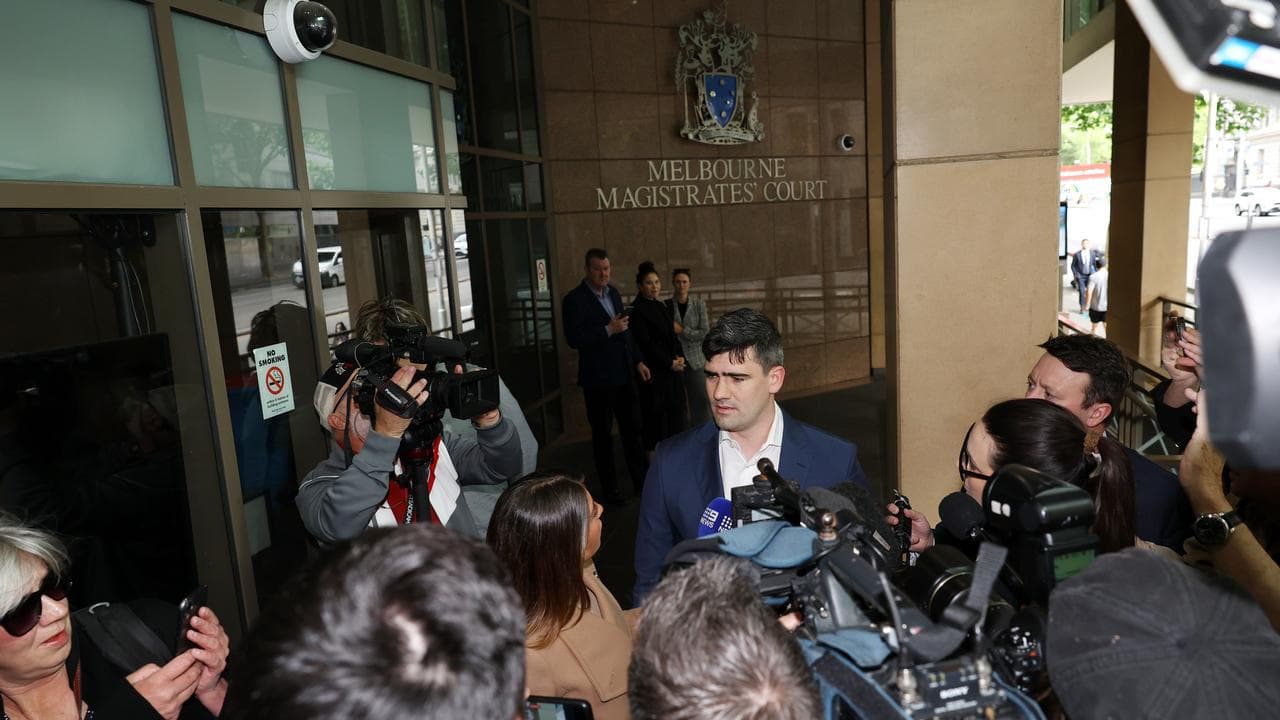 Jacob Hersant (centre) speaks to media