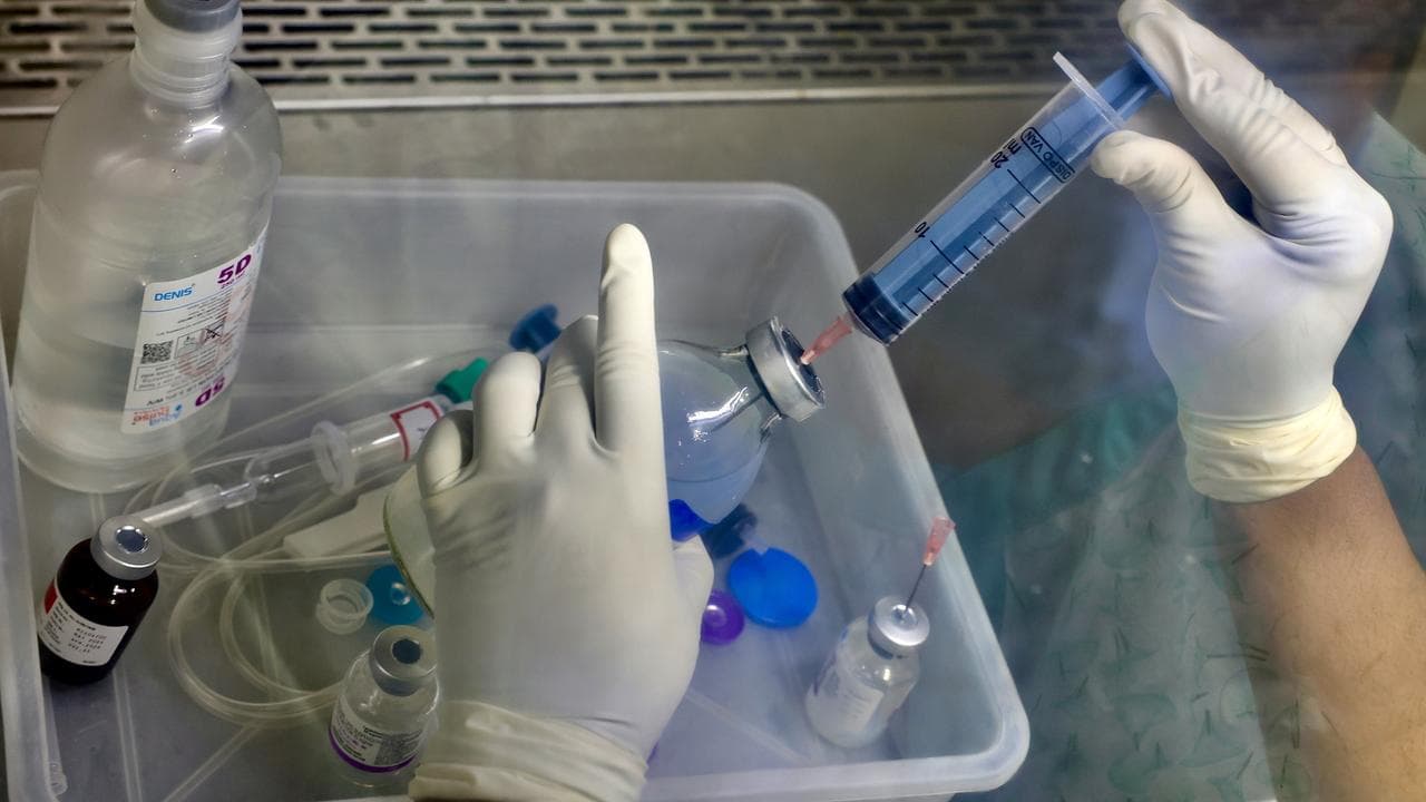 A doctor handling cancer treatment medicines.