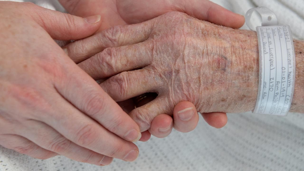 Nurse hold the hand of a patient