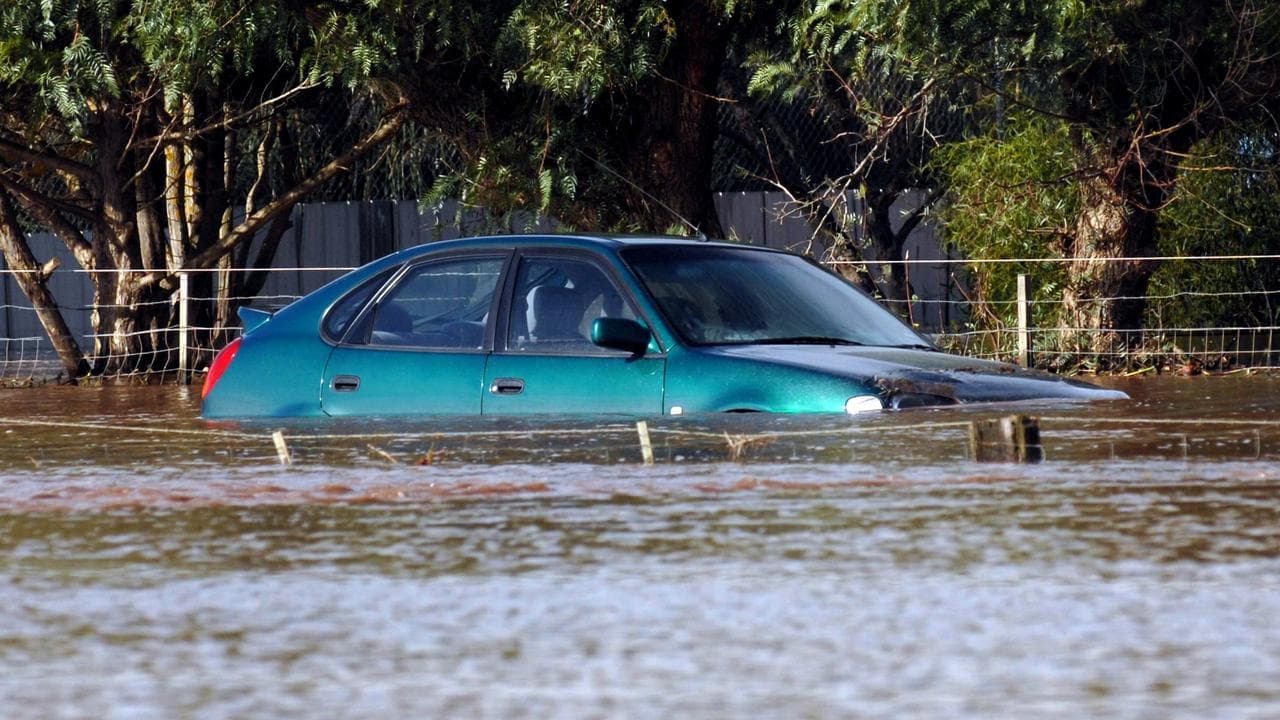 A car is inundated by rising floodswaters (file image)