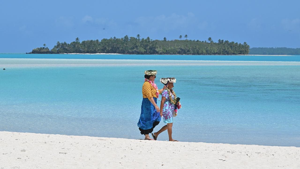 Locals walking on the beach the Cook Islands (file image)