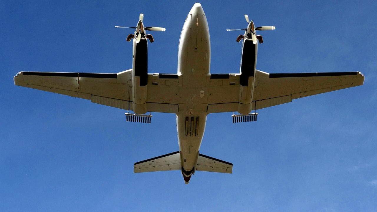 An aircraft fitted with cloud seeding cannisters.