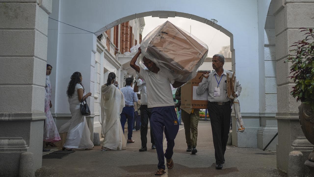Polling workers return to a counting centre in Colombo, Sri Lanka