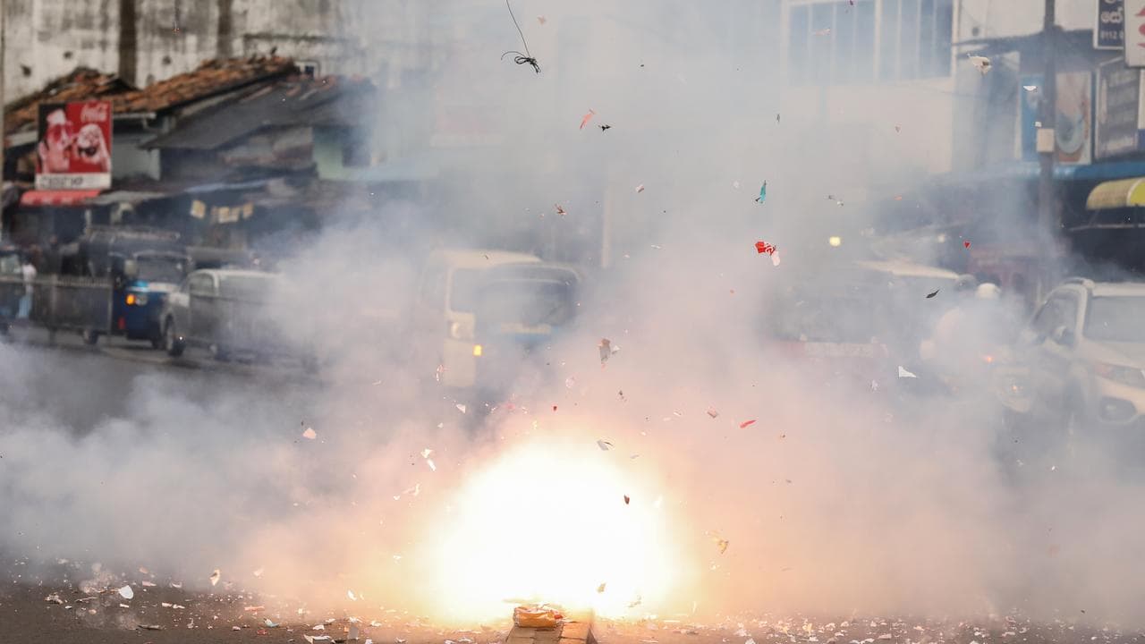 People light firecrackers after the election in Colombo, Sri Lanka
