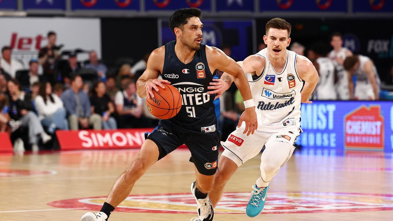 Melbourne United's Shea Ili (left) drives towards the basket.