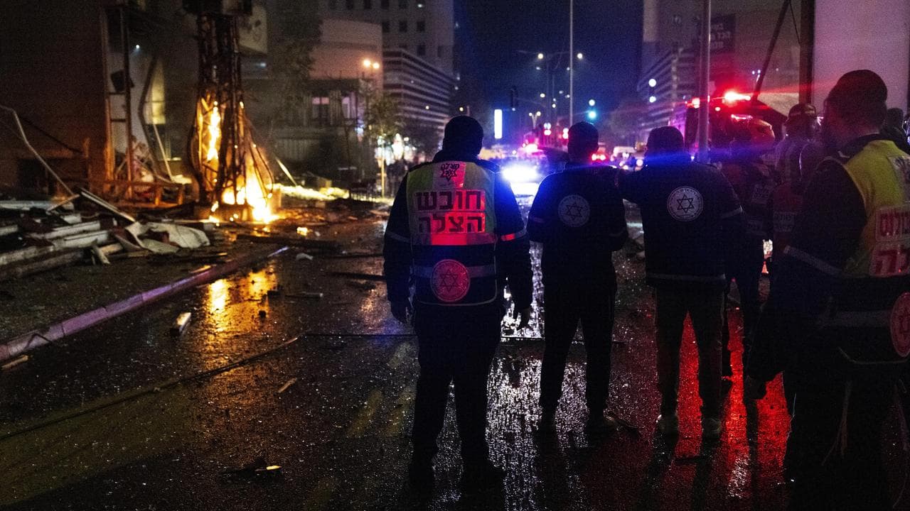 Security forces inspect the location of a rocket attack in Tel Aviv
