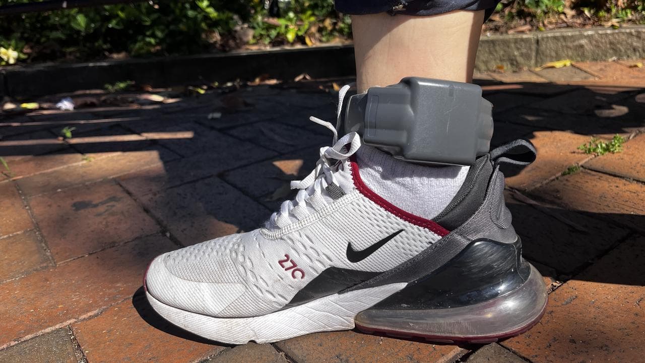 A man released from immigration detention, wearing an ankle monitor