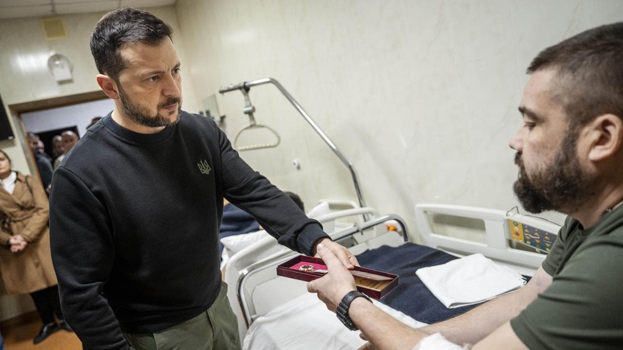 Ukraine's President Volodymyr Zelenskyy awards a medal to a soldier