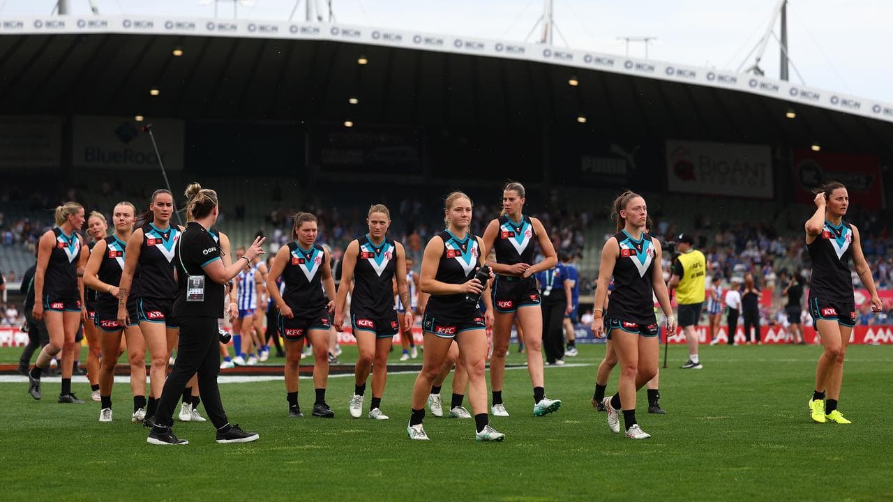 Port Adelaide players leave the field.