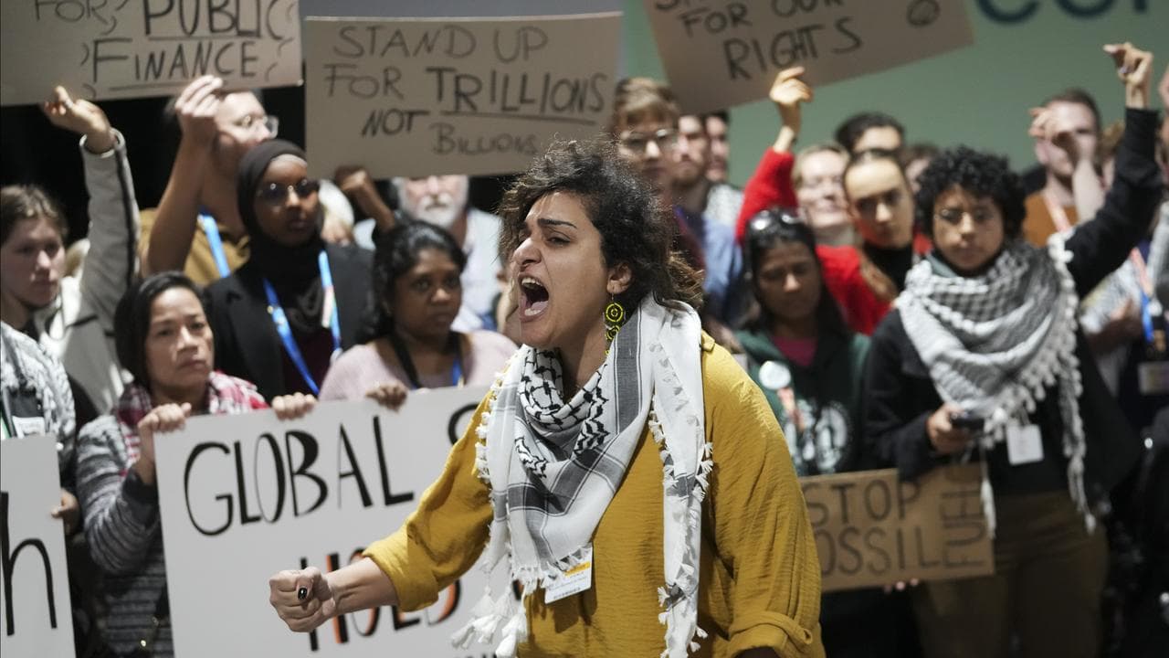 Activists participate in a demonstration for climate finance