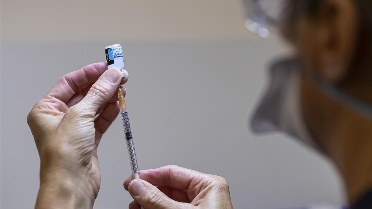 A health care worker prepares a vaccine
