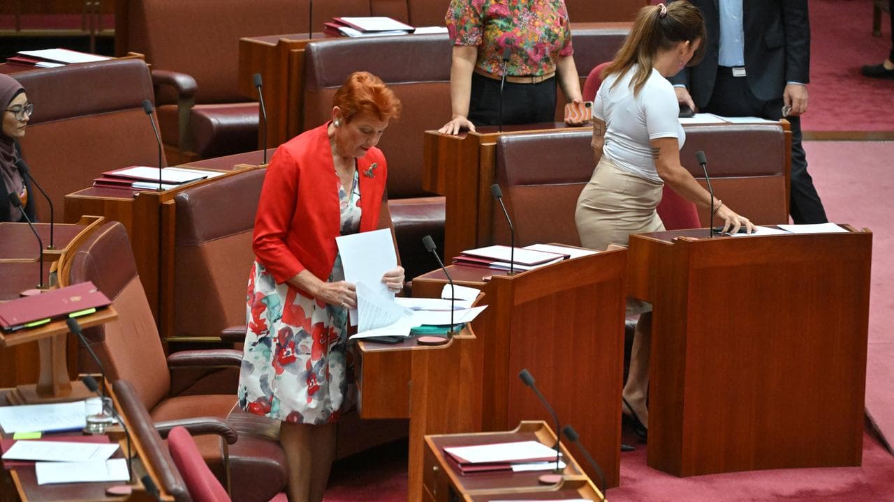 Lidia Thorpe (L) leaves after throwing papers at Pauline Hanson