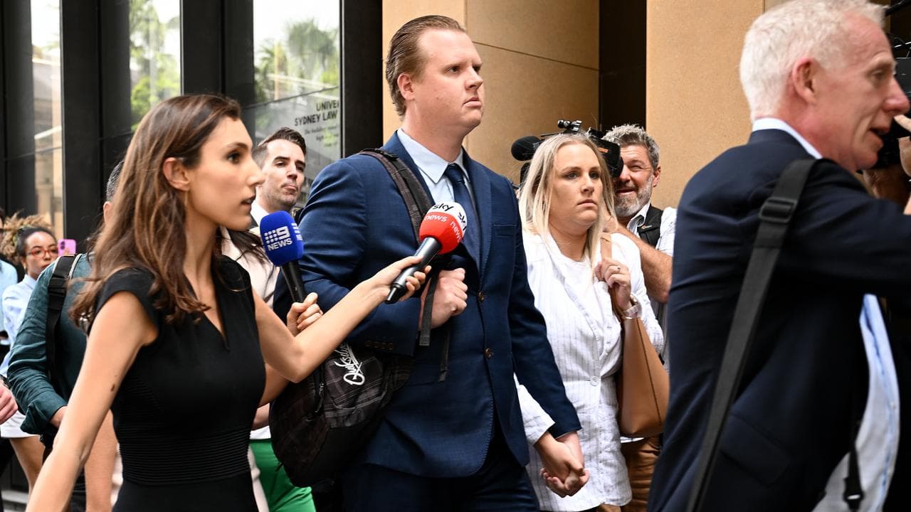 Kristian White (centre) departs the Supreme Court
