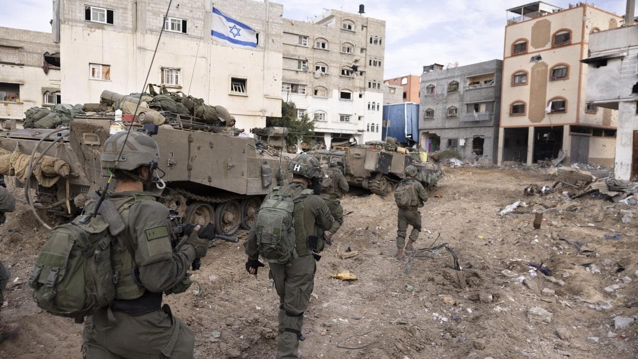 Israeli soldiers walk in Gaza City