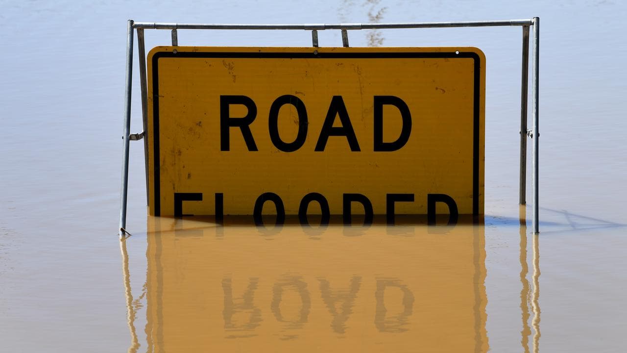 Road flooded sign partially submerged