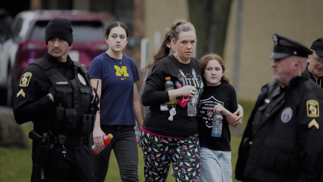 A family leave after a shooting at the Abundant Life Christian School