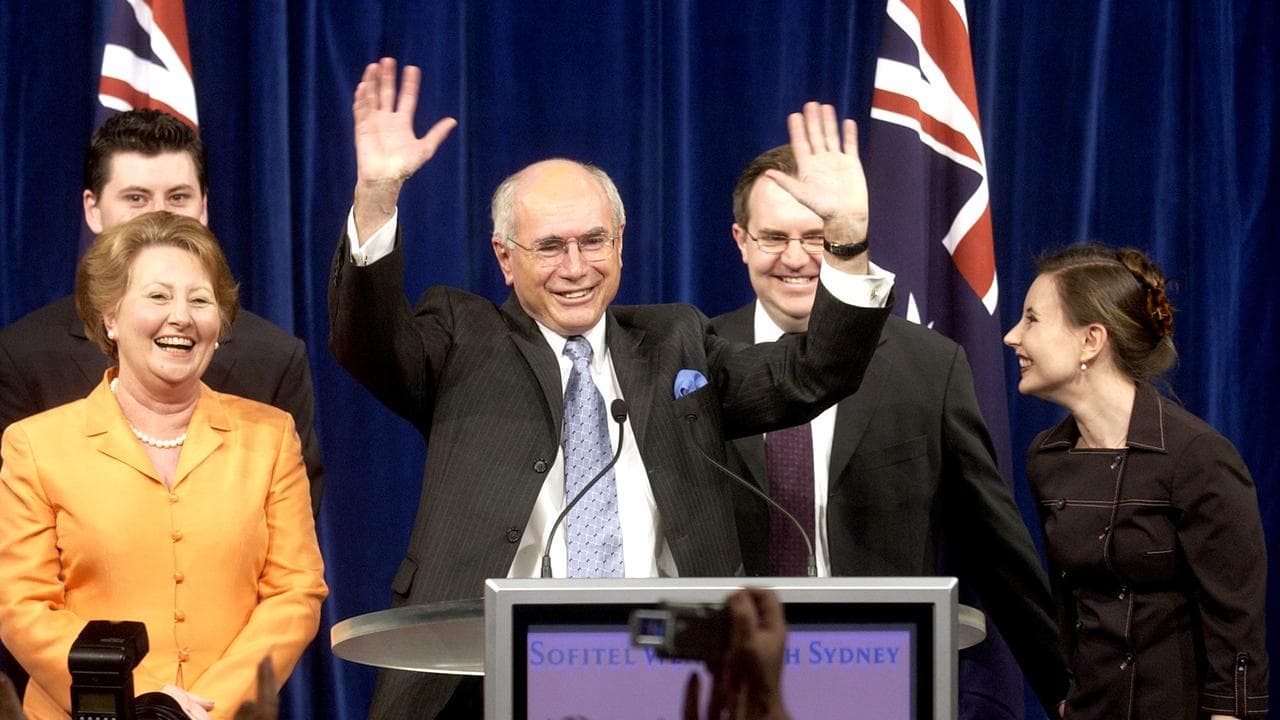 John Howard waves to supporters after winning the 2004 election
