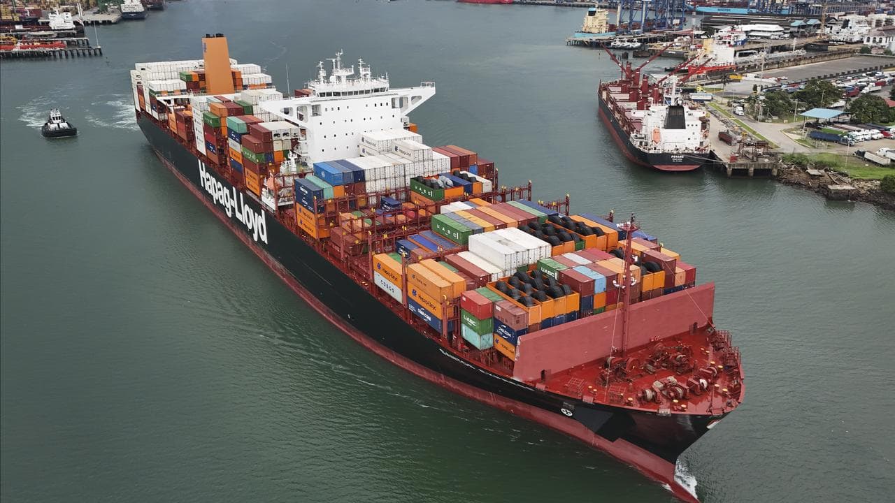 A cargo ship sails through the Panama Canal,