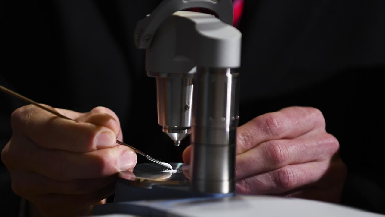 A man uses the Compact FTIR Spectrometer pill testing machine