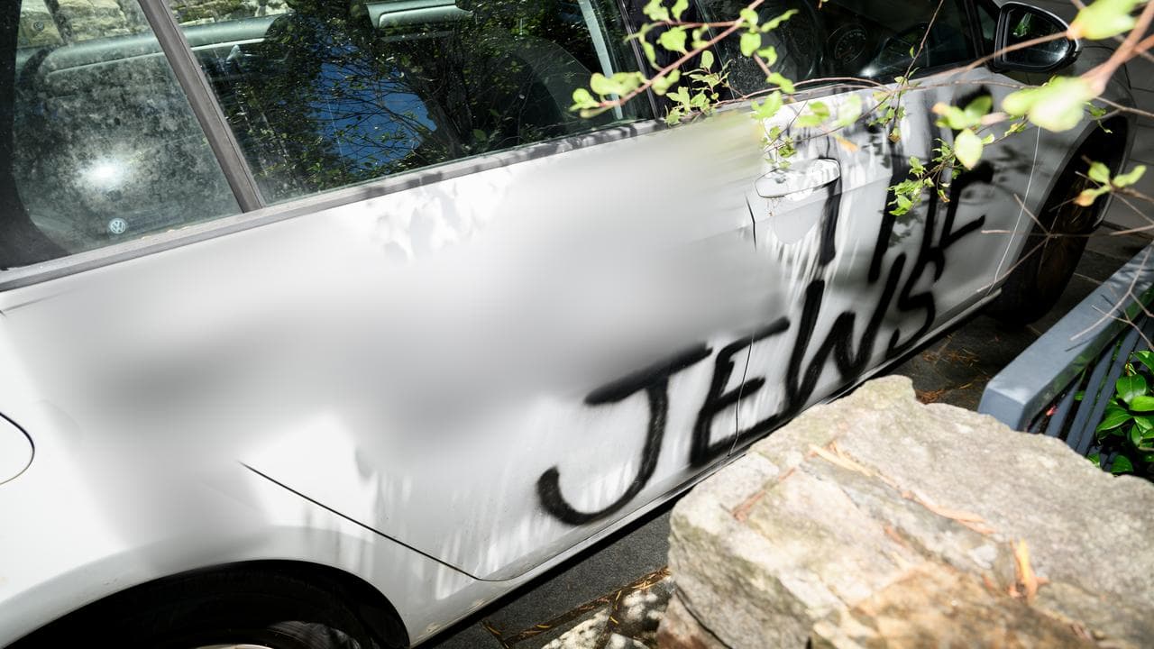 Anti-Semitic slogan sprayed on the side of a car
