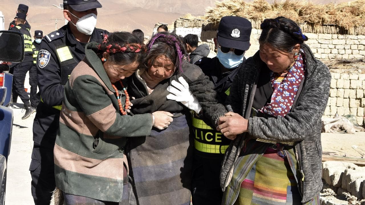 Chinese rescuers transfer people injured in an earthquake in Tibet