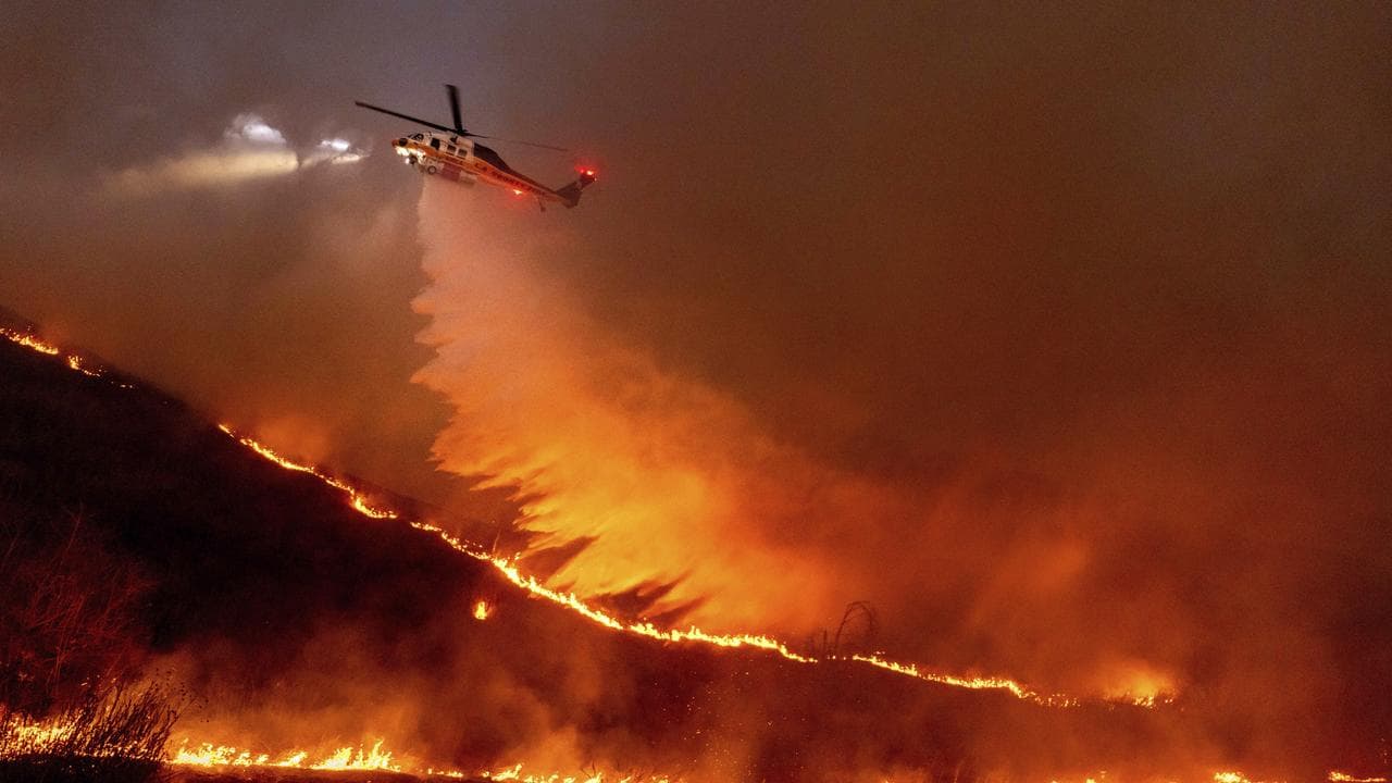 Water is dropped by helicopter on the Kenneth Fire