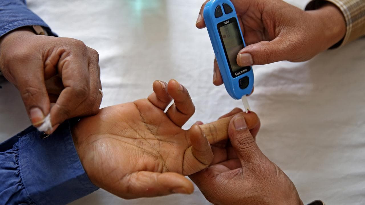 A man undergoes a blood sugar test.