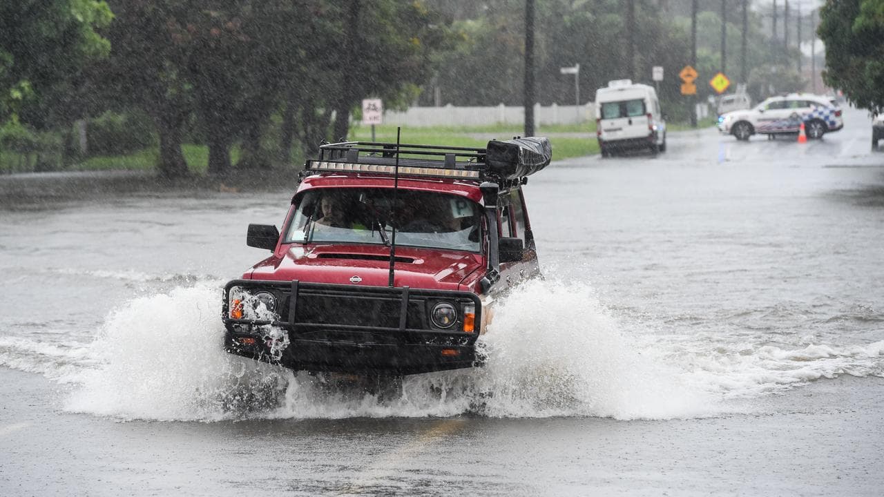 Car driving through floodwaters