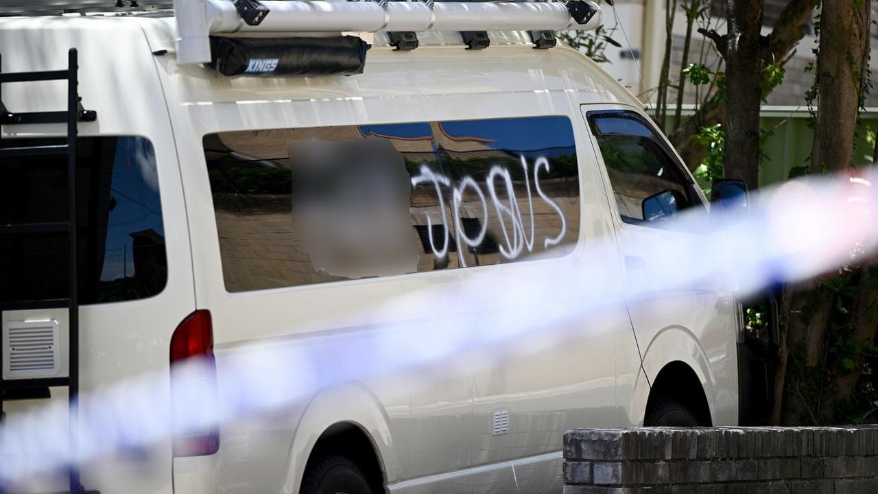 An anti-Semitic slur is seen graffitied on the side of a van