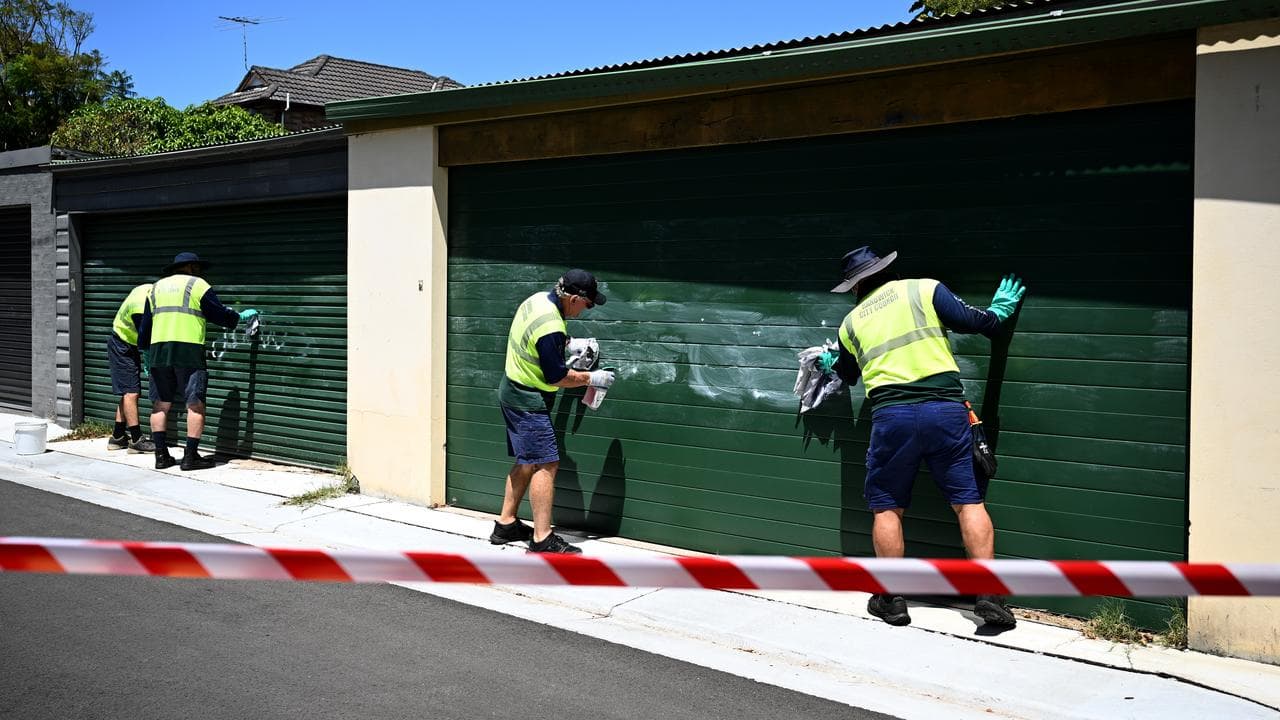 Council workers removing anti-Semitic slurs