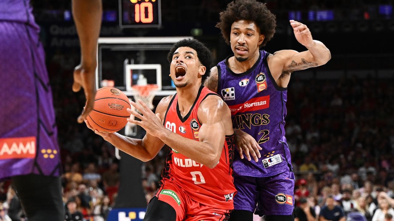 Tai Webster (front) feels the pressure from the Kings' Jaylen Adams