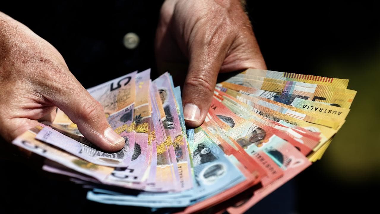 A man holds cash in his hands