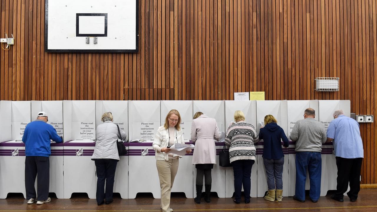 Voters complete their ballots at a voting centre.