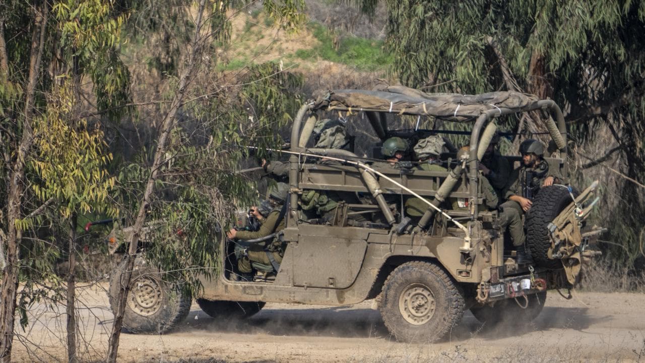 Israeli soldiers drive near the northern Gaza Strip