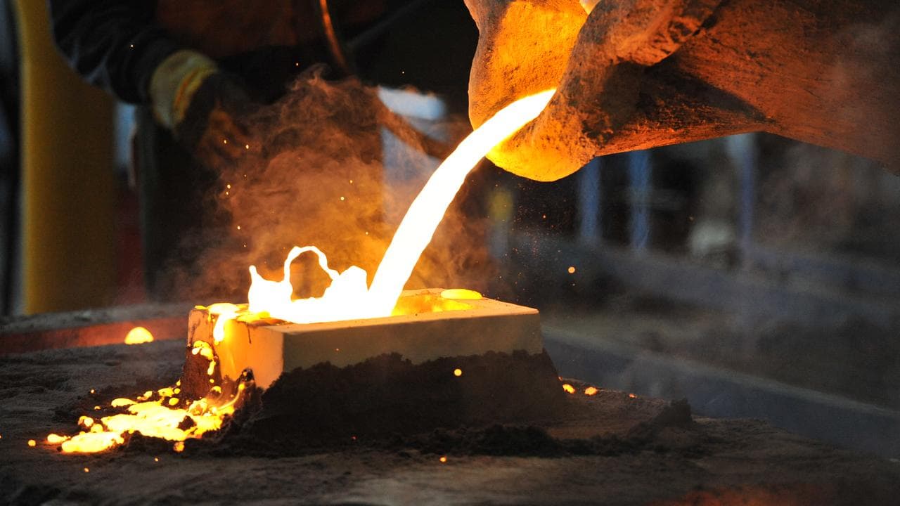 A factory worker pours molten iron (file image)