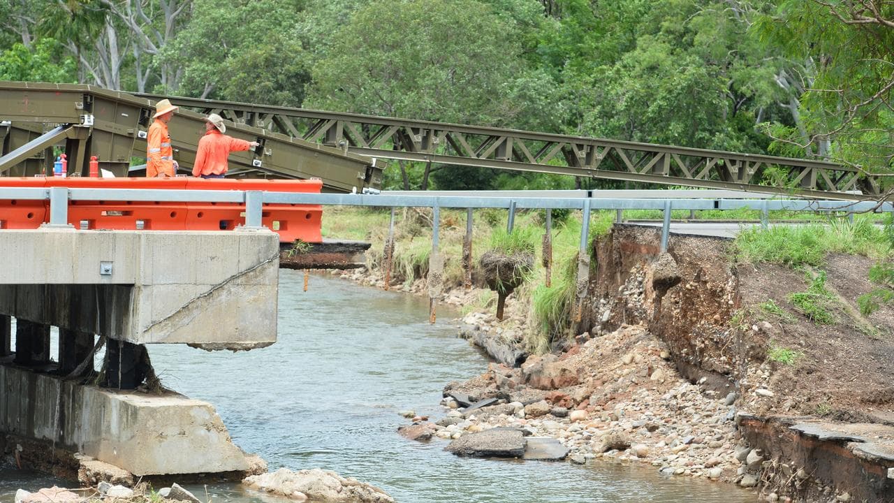 Australian Defence Force personnel repair a flood damaged bridge.