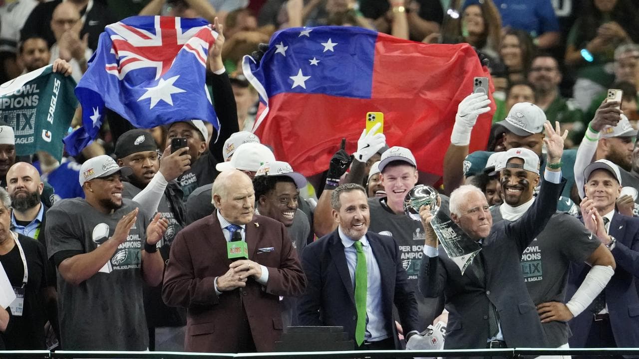 Eagles owner Jeffrey Lurie holds the Vince Lombardi trophy.