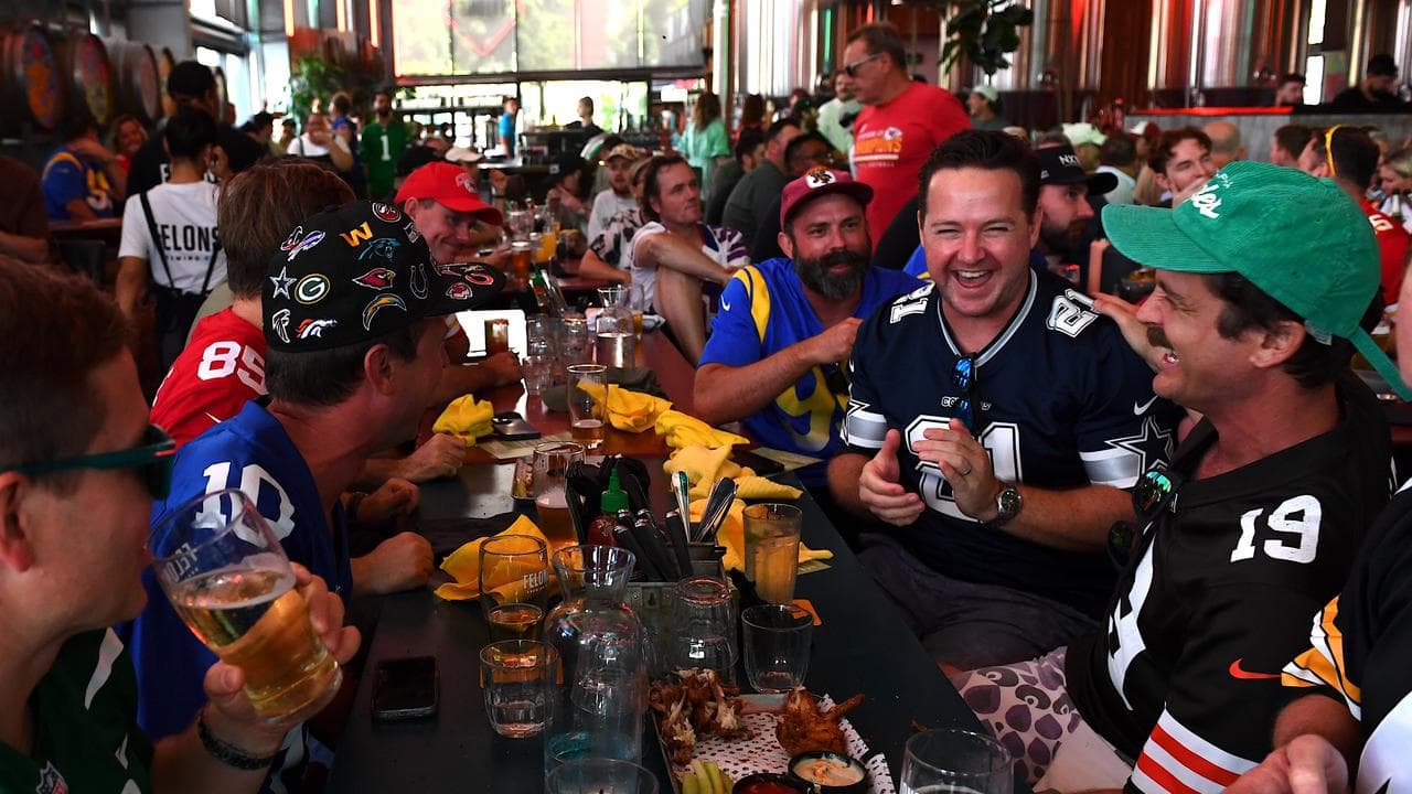 Fans react as they watch the Super Bowl