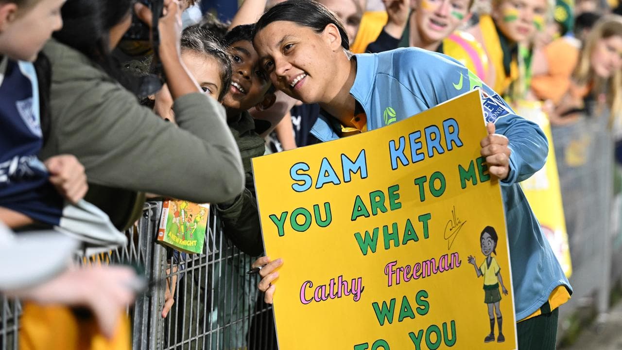 Sam Kerr of Australia signs autographs