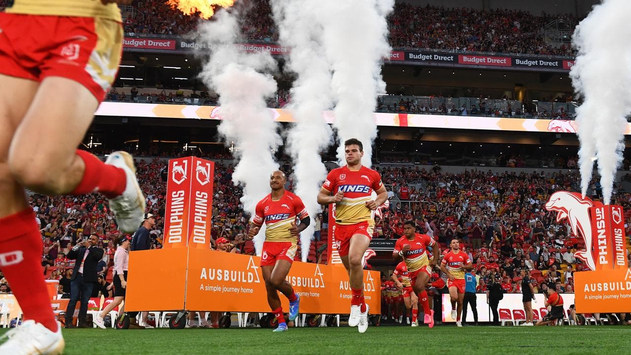 Dolphins players enter the field at Suncorp Stadium.