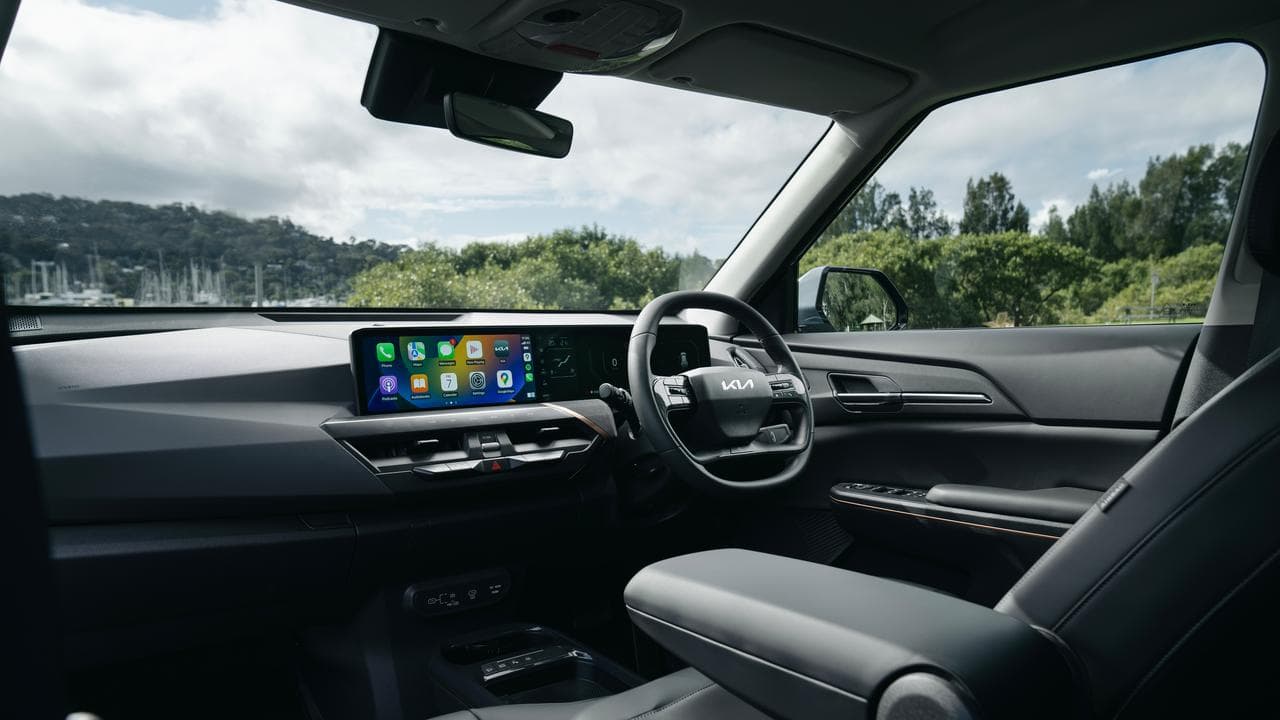 Interior photo of the Kia EV5, showing dashboard and steering wheel.