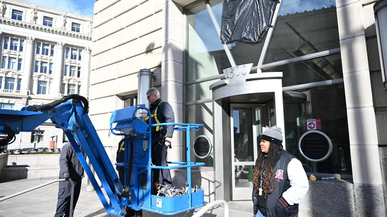 Crane crew after removing letters from USAID headquarters.